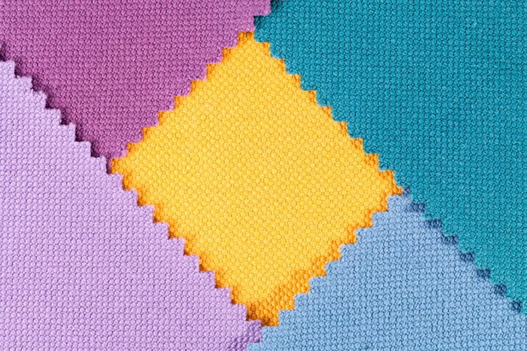 Composition of colored pieces of serrated cotton fabric