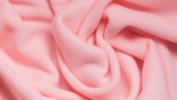 Background texture of pink fleece, soft napped insulating fabric made of polyester